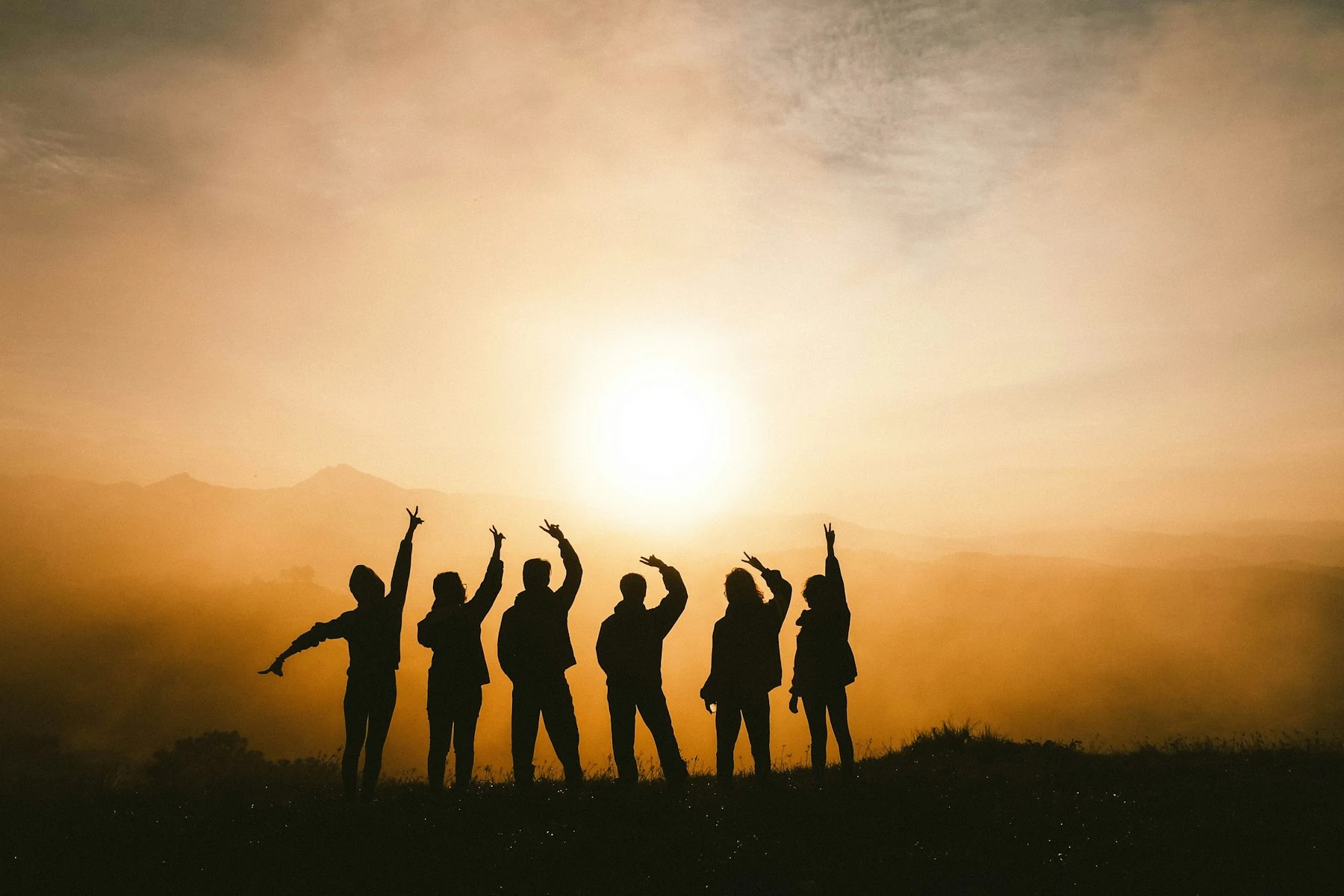 Friends outdoors together at sunset